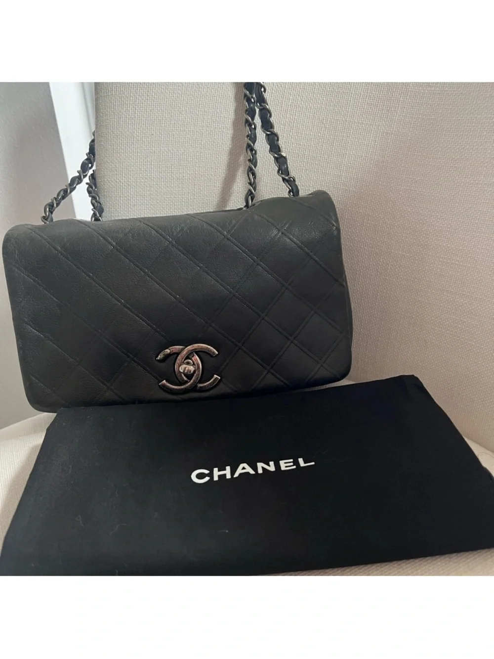 CHANEL Black Quilted Lambskin Shoulder Bag with Silver CC Lock.